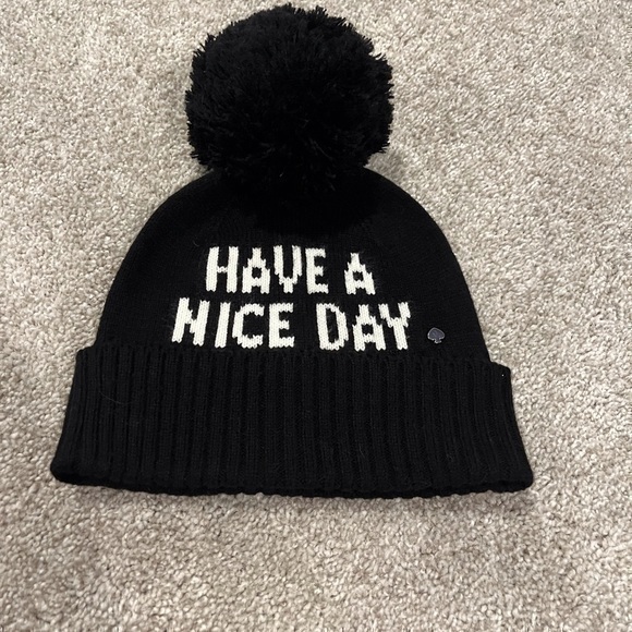 kate spade Accessories - Kate Spade black have a nice day pom Pom beanie hat
